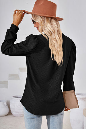 Black textured puff sleeve henley blouse with a subtle geometric pattern.