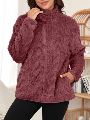 Burgundy textured chevron fleece zip jacket with stand-up collar and pockets.