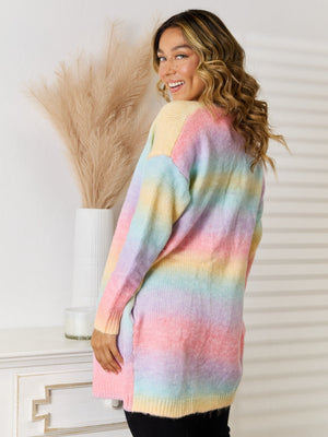 Rainbow gradient longline knit cardigan with pastel stripes and long sleeves.