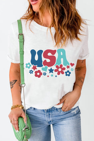 White graphic t-shirt with groovy USA text and floral pattern