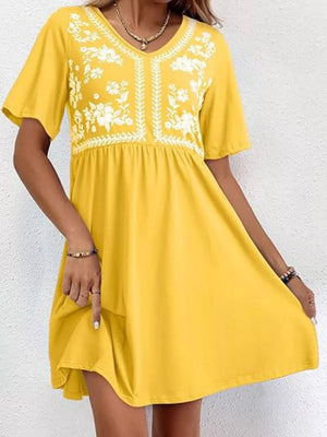 Yellow embroidered floral v-neck mini dress with short sleeves and a flowy skirt.