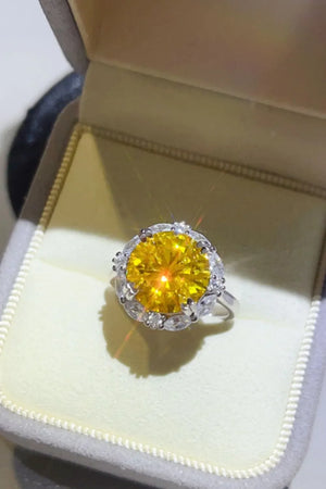 Radiant Halo Yellow Gemstone Ring with clear accent stones in a silver band.