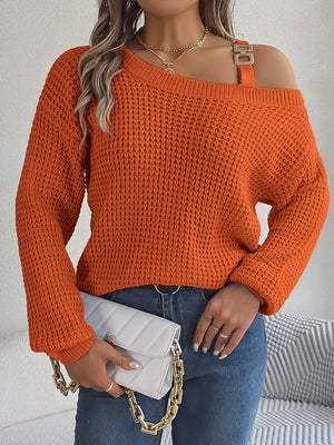 One-shoulder knit sweater in pumpkin orange with buckle detail and waffle texture.