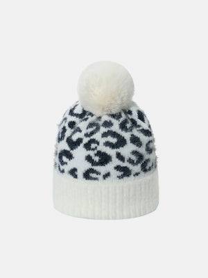 White acrylic beanie with black leopard print and white pom pom.