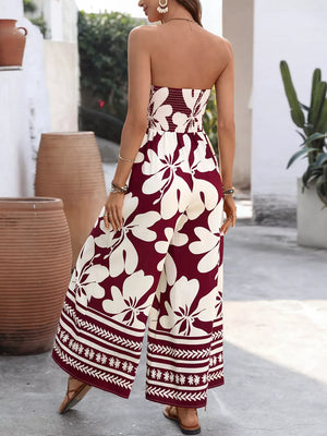 Burgundy floral strapless romper with wide legs and smocked bodice detail.