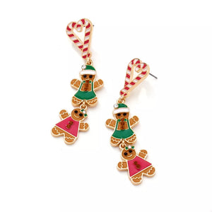 Festive gingerbread man dangle earrings with candy cane tops, green and pink dresses.