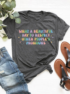 Dark gray polyester t-shirt with "What a beautiful day to respect other people's pronouns" graphic text.