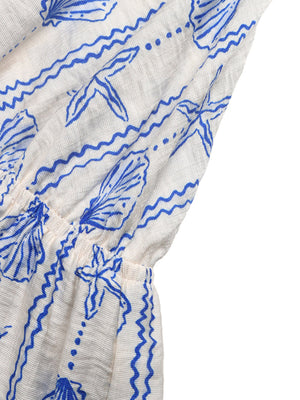 White maternity romper with blue seashell and wave print, cinched waist detail