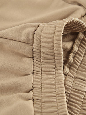 Camel quarter zip top and pants set detail with elastic waistband and drawstring.