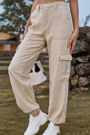 Tan utility cargo pants with multiple pockets and elastic cuffs.