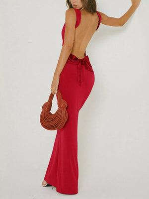 Red backless maxi dress with bow detail and flared hem.