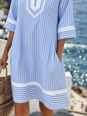 Blue and white striped V-neck dress with pockets and contrast trim.