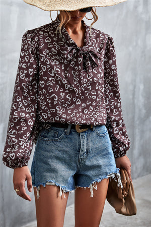Brown abstract print pussy bow blouse with balloon sleeves.