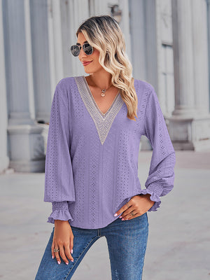 Periwinkle eyelet blouse with lace trim V-neck and ruffled cuffs.