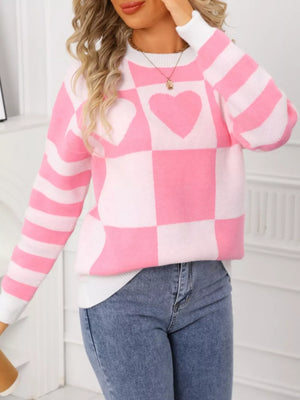 Blush pink and white checkerboard knit sweater with heart details and striped sleeves.
