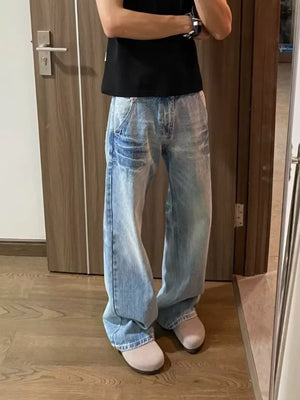 Men's light wash vintage wide-leg jeans with distressed details.