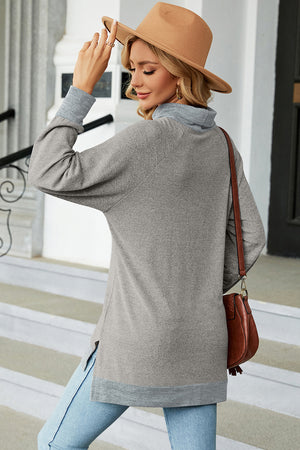 Colorblock raglan turtleneck tunic in light gray with contrasting gray cuffs and hem, side slits.