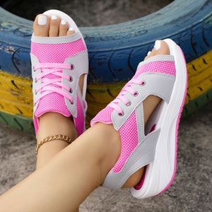 Sporty lace-up wedge sandals in pink and gray mesh with white soles.