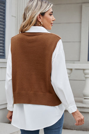 Caramel cable knit vest with ribbed hem, worn over a white shirt.
