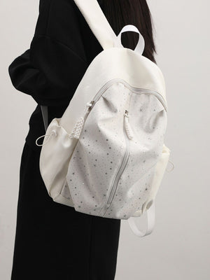 White nylon school backpack with all-over silver stars and braided zipper pull.