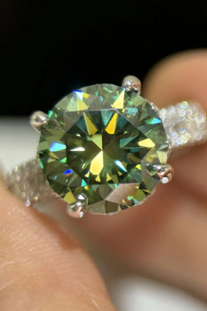 Emerald cut halo engagement ring in dark green sterling silver with a bright, sparkling stone.
