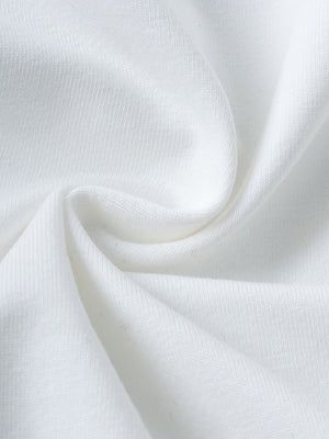 White baby set fabric detail with a soft texture.