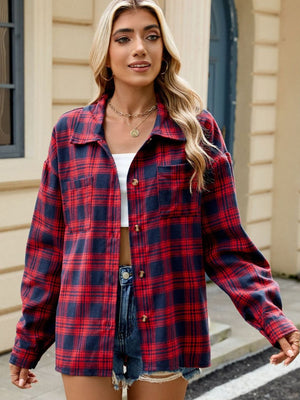 Checkered long sleeve collared top in red and navy plaid with button front and chest pockets.