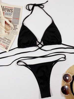Black ribbed halter bikini set with crisscross detail and string tie bottoms.