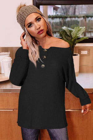 Black waffle knit henley tunic with button detail and boat neck.