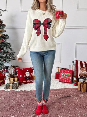 Cream ribbed knit sweater with a large red plaid bow detail, crew neck.