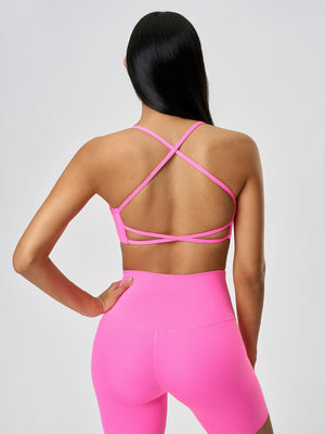 Fuchsia pink active crop top with strappy back detail.