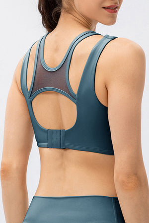Mesh inset performance bra top in dark blue with cutout back detail and adjustable clasp