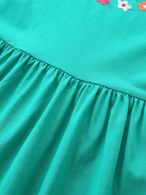 Turquoise A-line dress for kids with floral appliqué detail and gathered skirt.