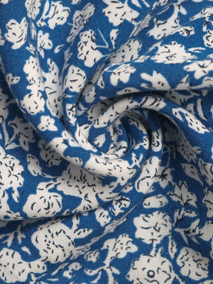 Light blue mini skirt with a ditsy floral print and ruffle detail.