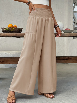 Smocked waist wide leg cotton pants in beige with a relaxed fit.