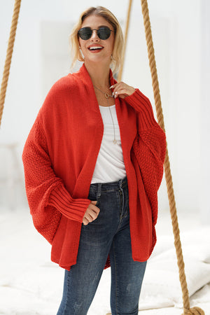 Orange-red acrylic cocoon knit sleeve cardigan with open front and textured sleeves.