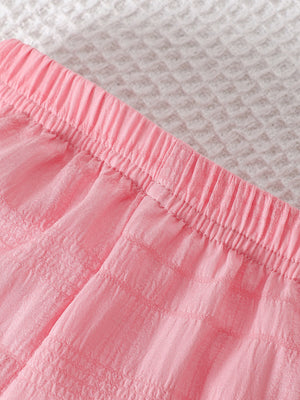Pink baby pants with elastic waistband and textured fabric detail