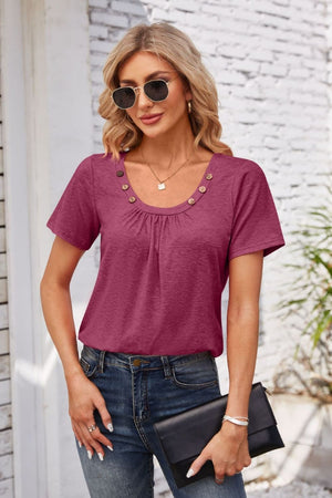 Button-trimmed gathered yoke top in watermelon pink with short sleeves and a scoop neckline.
