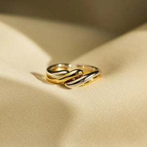 Two-tone gold intertwined open ring with a smooth, fluid design.
