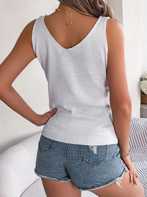 White mesh knit vest with V-neck and ribbed hem, styled with denim shorts.