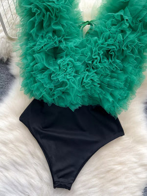 Green ruffled V-neck bodysuit with black bottom and lace detail