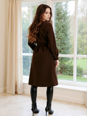Brown tailored double-breasted trench coat with waist tie and buttoned cuffs.