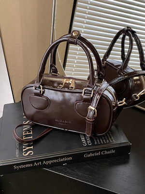 Chic mini crossbody bag in chocolate PU leather with top handles and adjustable strap.