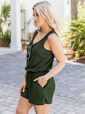 Button-front drawstring waist romper in dark green with v-neck and short legs.