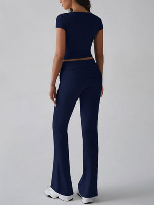 Dark blue ribbed flare leg lounge set with short sleeve crop top and high waist pants.
