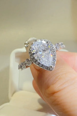 Silver pear-cut halo moissanite ring with accent stones on band