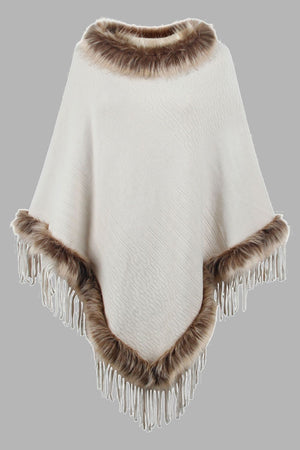 Ivory textured knit poncho with faux fur trim and fringe details.