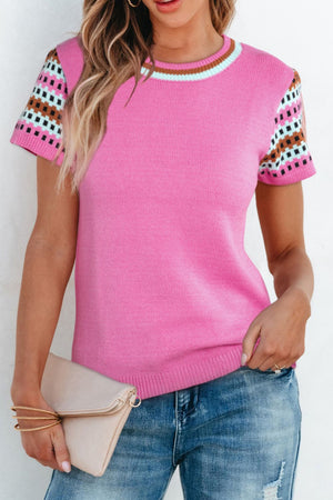 Fuchsia pink knit top with geometric patterned short sleeves and striped neckline.