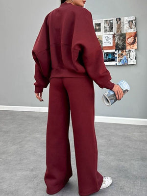 Burgundy zip-up sweatshirt and wide-leg pants set with crew neck and relaxed fit.