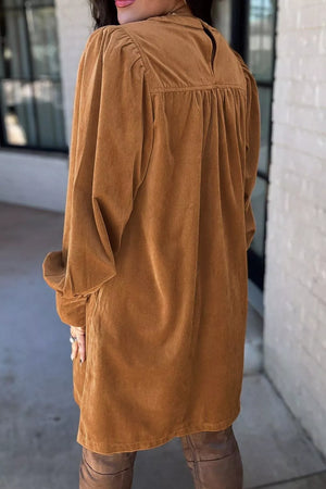 Caramel corduroy mini dress with puff sleeves and buttoned cuffs.